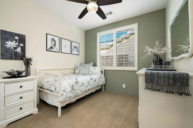 bedroom with ceiling fan and light carpet