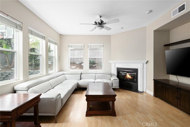 living room with ceiling fan and light hardwood / wood-style flooring