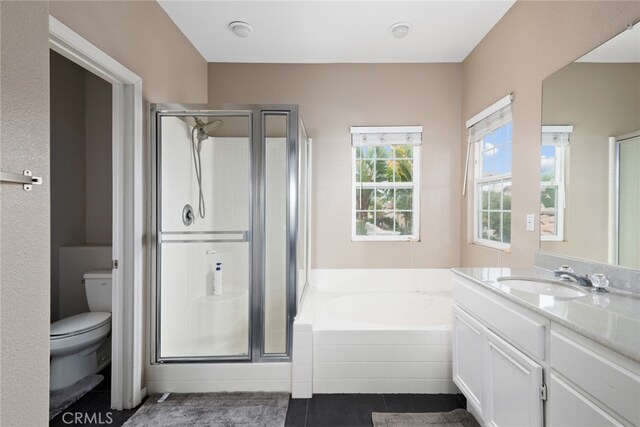 full bathroom with tile patterned floors, plus walk in shower, vanity, and toilet