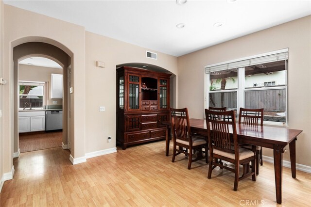 dining room with light hardwood / wood-style floors and sink