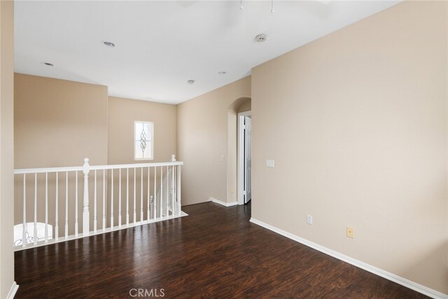 unfurnished room with dark hardwood / wood-style floors