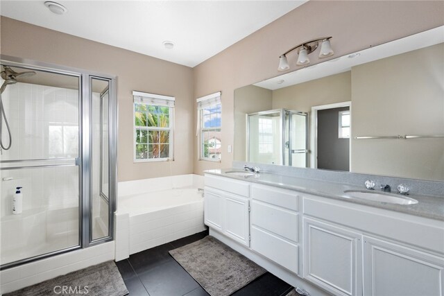 bathroom featuring tile patterned floors, vanity, and shower with separate bathtub