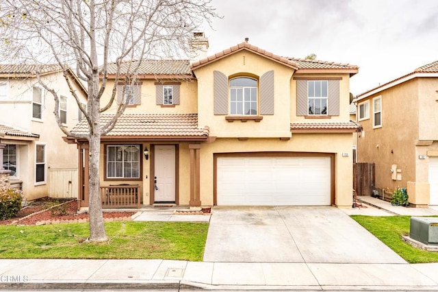 mediterranean / spanish-style home featuring a tiled roof, concrete driveway, a chimney, and stucco siding