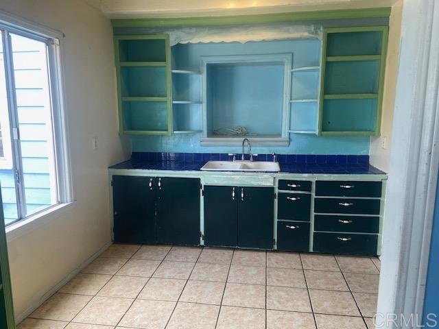 341 Brooks, Oceanside, CA 92054 - kitchen featuring open shelves, dark cabinetry, and healthy amount of natural light