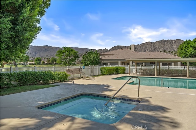 view of swimming pool featuring a patio area and a mountain view