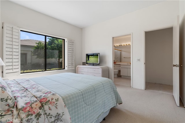 carpeted bedroom with ensuite bath