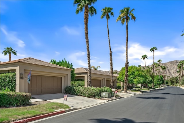 view of front of home with a mountain view and a garage