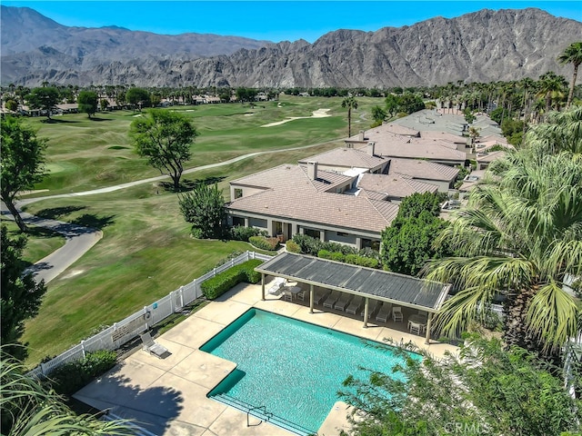 view of swimming pool with a mountain view, a yard, and a patio area