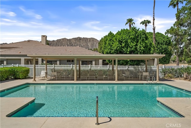 view of swimming pool with a mountain view and a patio area