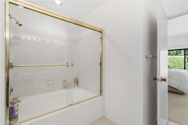 bathroom featuring bath / shower combo with glass door