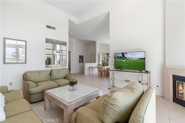 tiled living room with a towering ceiling