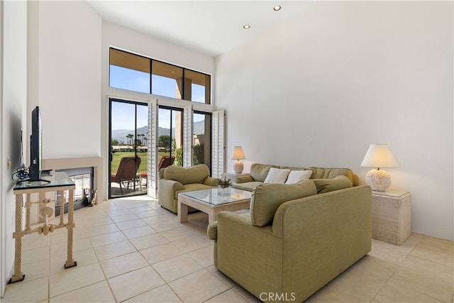 living room featuring a towering ceiling and light tile patterned floors