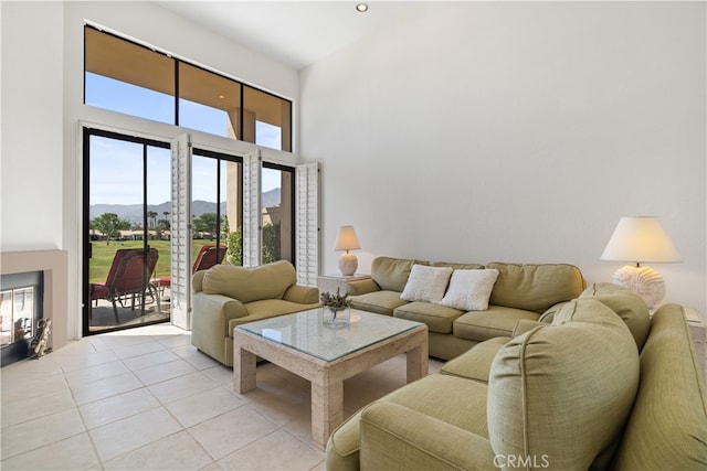 tiled living room featuring a towering ceiling