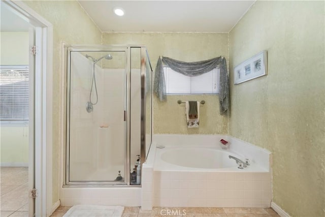 bathroom featuring tile patterned flooring and separate shower and tub