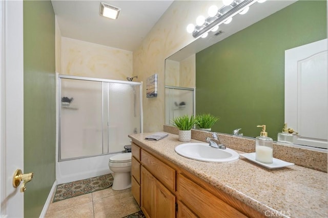 full bathroom with tile patterned flooring, vanity, toilet, and shower / bath combination with glass door