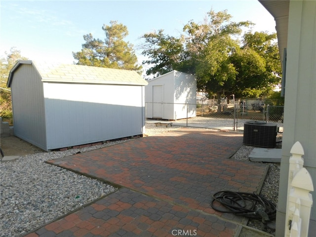 view of patio / terrace featuring a storage shed and cooling unit