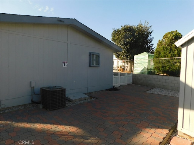 view of side of property featuring a patio area and central air condition unit