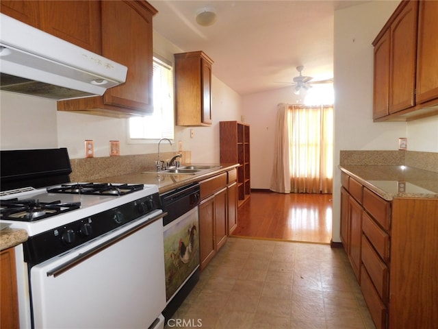 kitchen featuring light hardwood / wood-style floors, white gas range oven, dishwasher, ceiling fan, and sink