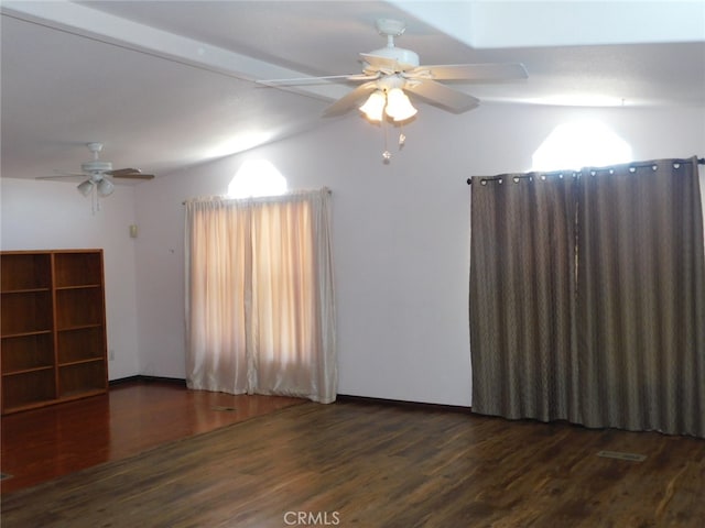 empty room with dark hardwood / wood-style flooring and ceiling fan