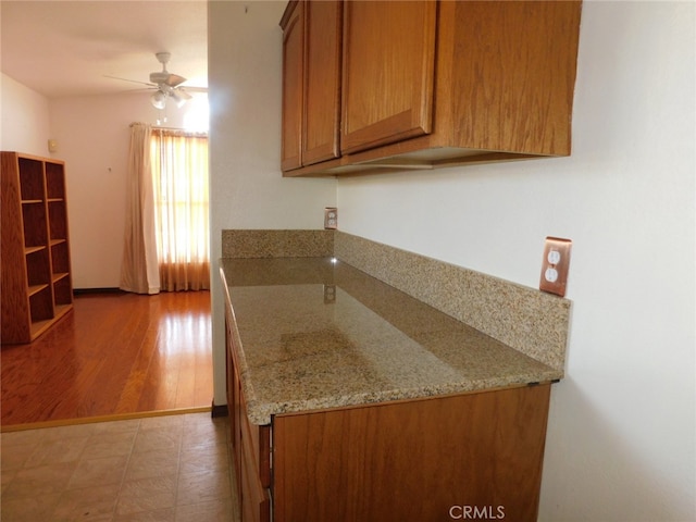 kitchen with ceiling fan and hardwood / wood-style floors