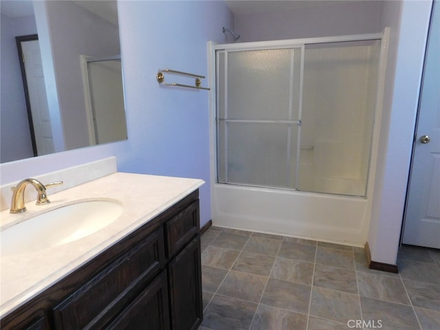 bathroom featuring shower / bath combination with glass door and vanity