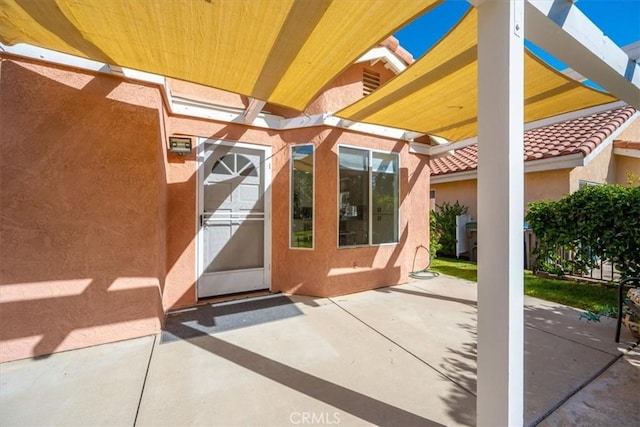 property entrance featuring a patio