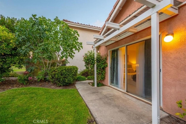 doorway to property with a yard