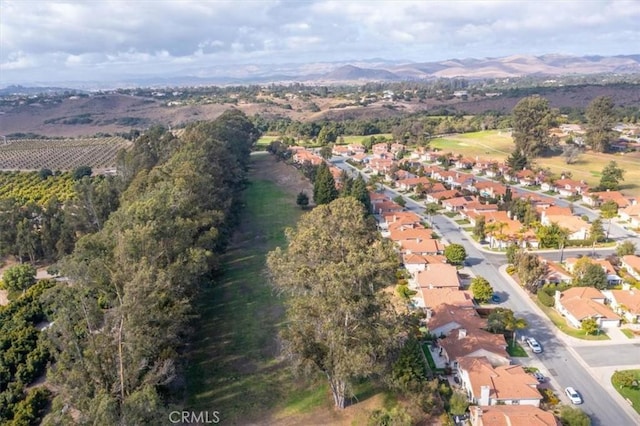 birds eye view of property featuring a mountain view