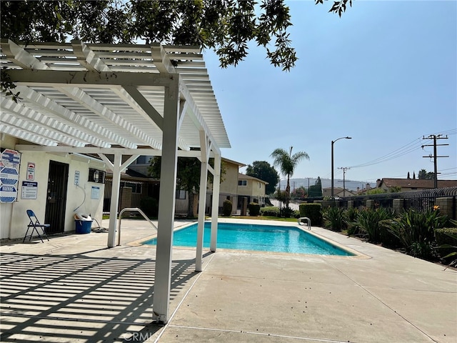 view of pool with a pergola and a patio area