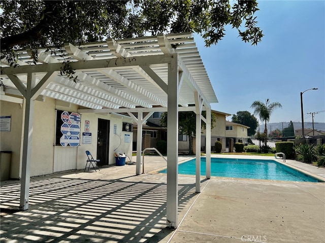 view of pool featuring a pergola and a patio