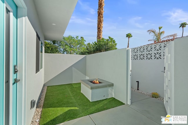 view of yard with a patio and a fire pit