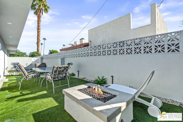 view of patio / terrace with an outdoor fire pit