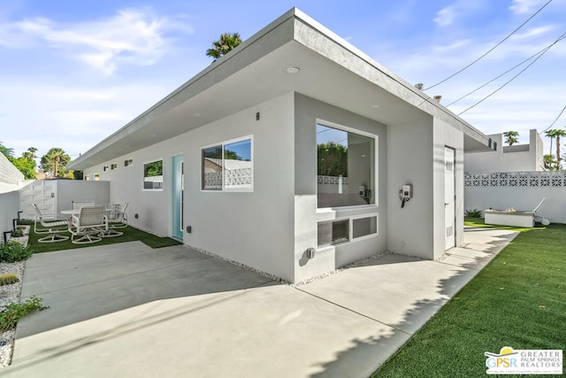 rear view of property featuring a patio area