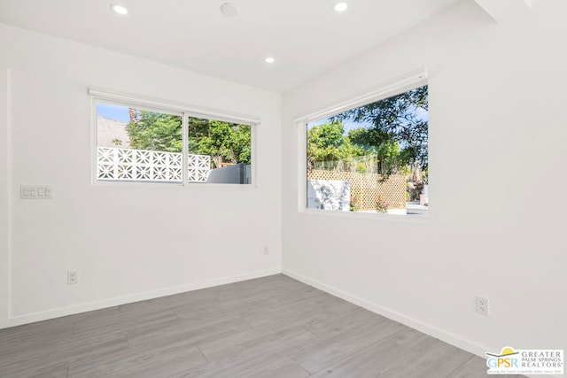 unfurnished room with hardwood / wood-style floors