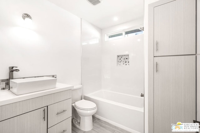 full bathroom with hardwood / wood-style flooring, vanity,  shower combination, and toilet