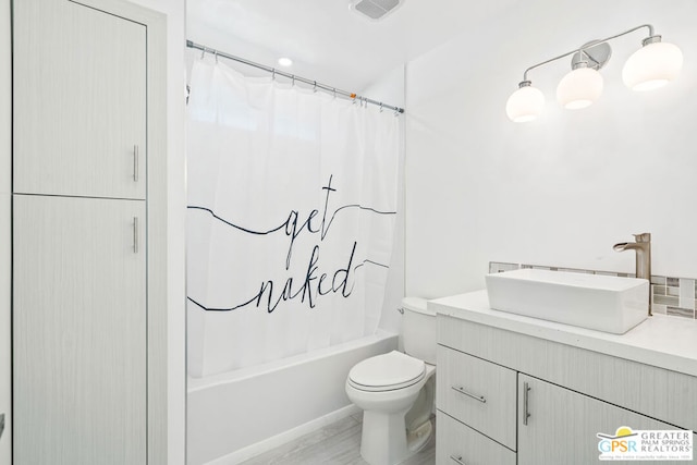 full bathroom featuring vanity, toilet, and shower / tub combo