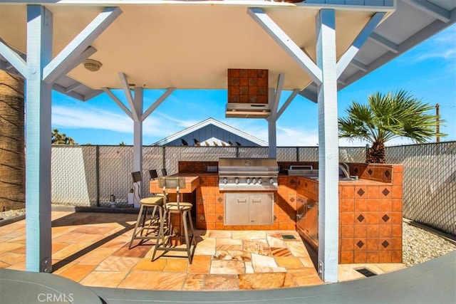 view of patio / terrace featuring area for grilling and a grill