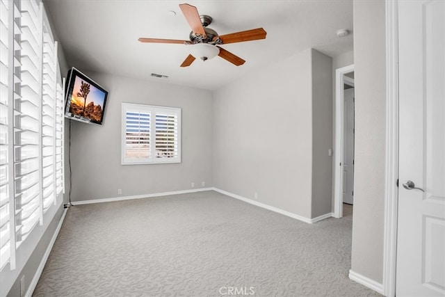 carpeted empty room with ceiling fan