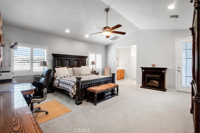 bedroom featuring multiple windows, lofted ceiling, ceiling fan, and light colored carpet