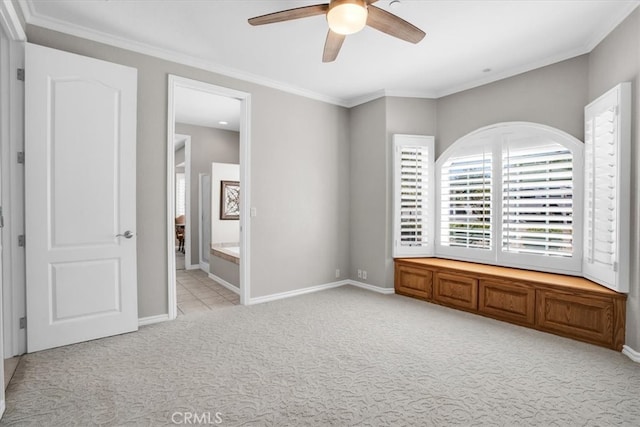 unfurnished bedroom with light colored carpet, crown molding, ceiling fan, and ensuite bathroom