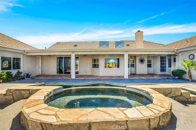 view of pool with a patio and an in ground hot tub