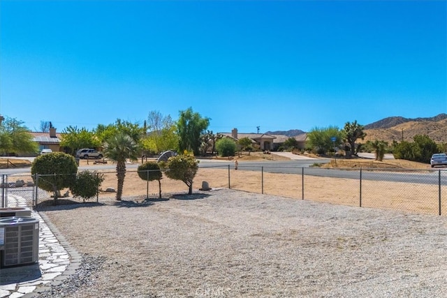 view of yard featuring a mountain view and central AC