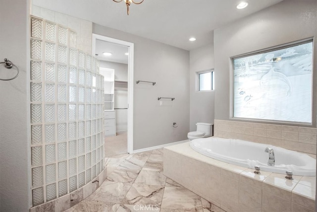 bathroom with tiled bath and toilet