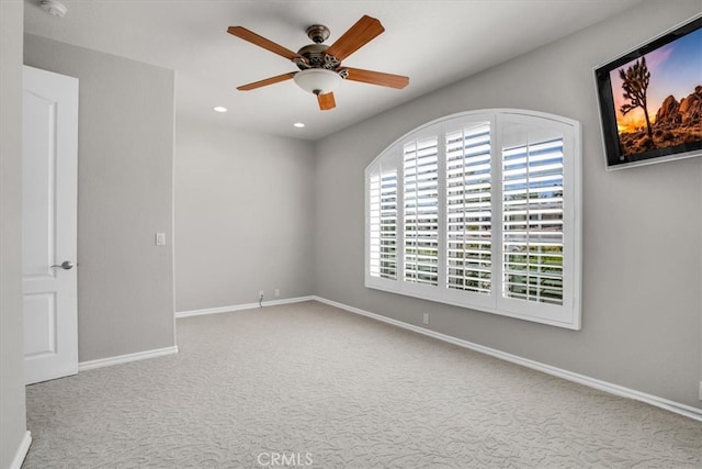 carpeted empty room featuring ceiling fan