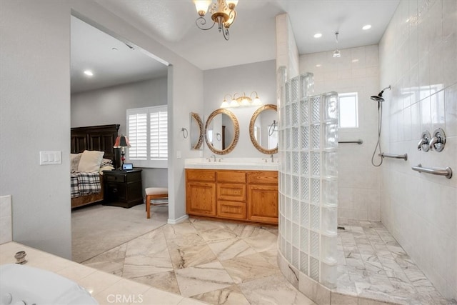 bathroom featuring a notable chandelier, independent shower and bath, and vanity