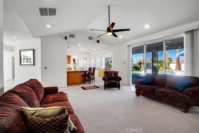 carpeted living room featuring lofted ceiling, ceiling fan, plenty of natural light, and sink