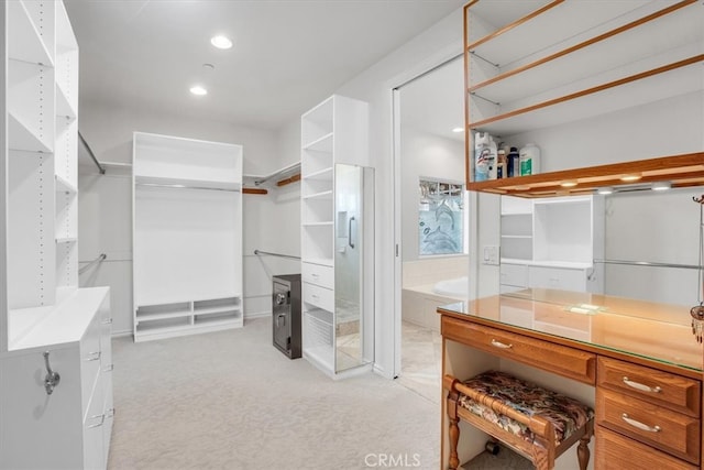 walk in closet featuring light carpet