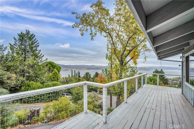 wooden terrace featuring a water view