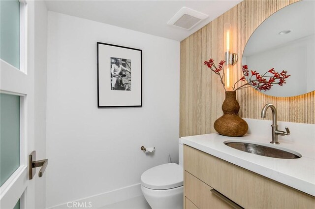 bathroom featuring vanity and toilet