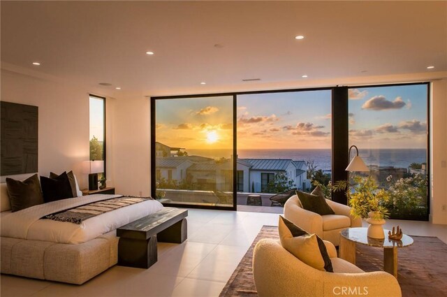 bedroom with a wall of windows and access to outside